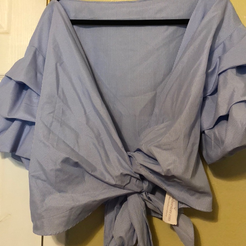 Dramatic puffy sleeve and ties up in the front.